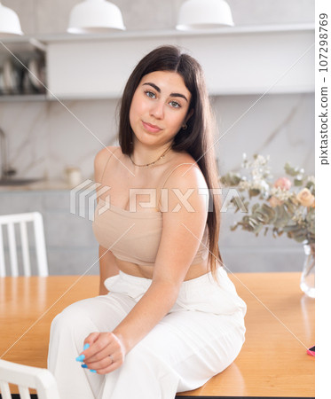 Young smiling woman posing in kitchen at home 107298769