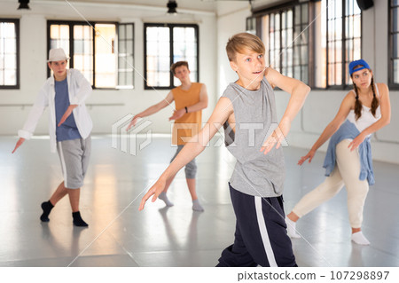 Group teenagers dancing hip-hop indoors Group teenagers dancing hip-hop indoors 107298897