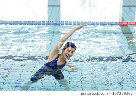 Women playing in the pool 107299362