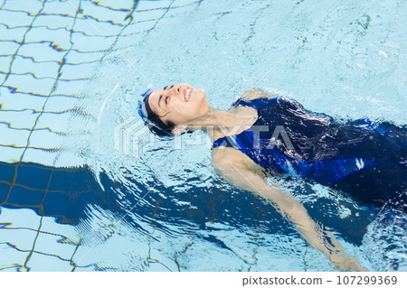 Woman swimming in the pool Woman swimming in the pool 107299369
