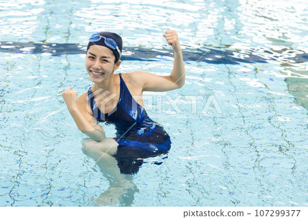 woman exercising in the pool woman exercising in the pool 107299377