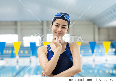 Pretty woman standing by the pool Pretty woman standing by the pool 107299439