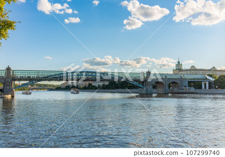 View of the Moscow river embakment, Pushkinsky bridge and cruise ships at sunset. 107299740