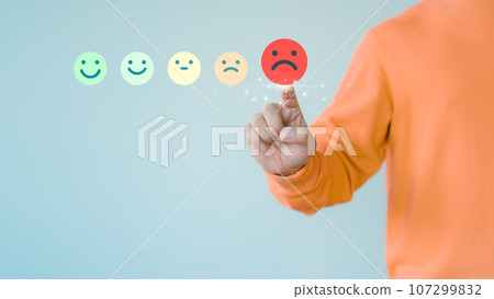 Customer hand touching the virtual screen on the angry emotion face. Assessment testimonial review for dislike service and low quality. Business concept of customer experience dissatisfied. Customer hand touching the virtual screen on the angry emotion face. Assessment testimonial review for dislike service and low quality. Business concept of customer experience dissatisfied. 107299832