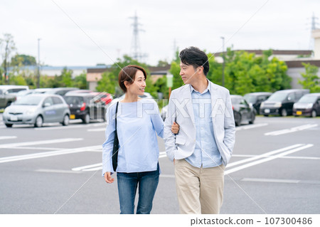 couple walking in parking lot 107300486