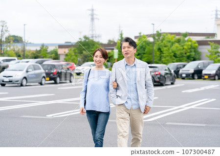 couple walking in parking lot couple walking in parking lot 107300487