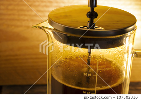 Fresh coffee in a French press coffee maker 107302310