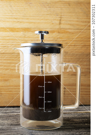 Fresh coffee in a French press coffee maker 107302311