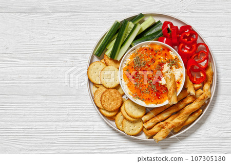 Hot Pepper Jelly Cheese Dip with crackers, veggies 107305180