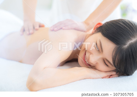 A middle-aged woman doing skin care at a beauty salon 107305705