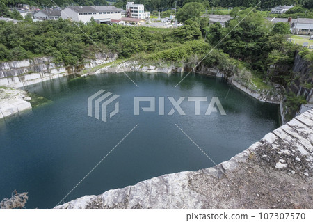 A lake filled with water at the site of a granite quarry A lake filled with water at the site of a granite quarry 107307570