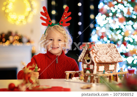 Kids baking gingerbread house. Christmas at home. 107308052