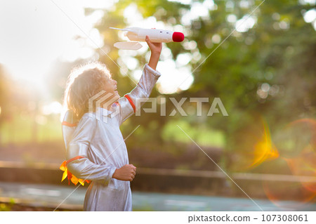 Little boy playing with spaceship. Astronaut kid. Little boy playing with spaceship. Astronaut kid. 107308061