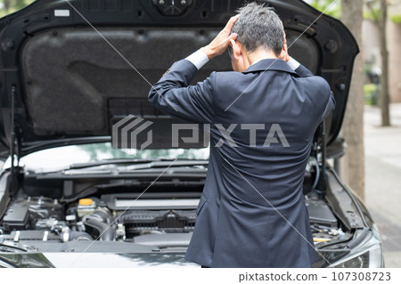 Businessman worried about car breakdown 107308723