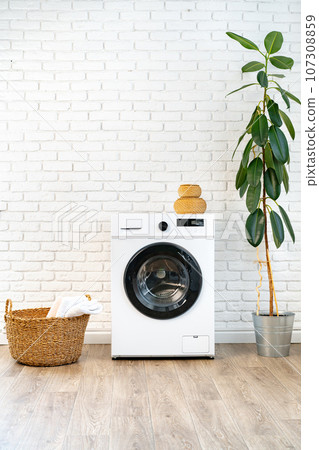 Washing machine and basket in a laundry room 107308859