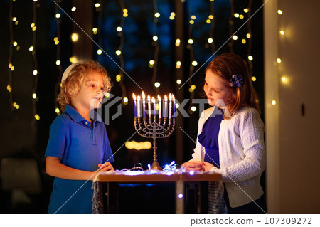 Kids celebrating Hanukkah. Festival of lights. Kids celebrating Hanukkah. Festival of lights. 107309272