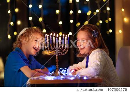 Kids celebrating Hanukkah. Festival of lights. 107309276