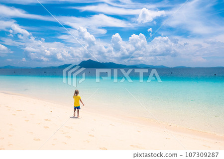 Kids playing on beach. Children play at sea. 107309287