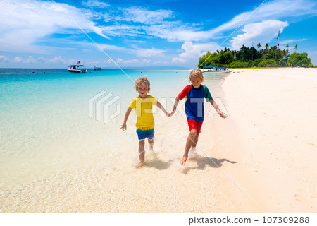 Kids playing on beach. Children play at sea. Kids playing on beach. Children play at sea. 107309288