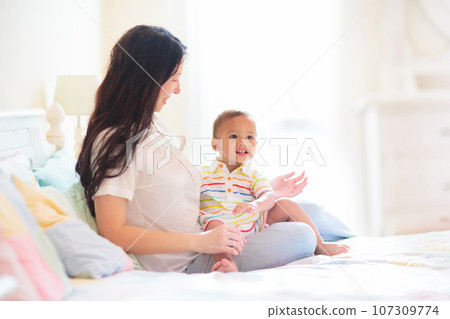 Baby and mother at home. Mom and child. Baby and mother at home. Mom and child. 107309774