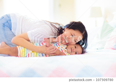 Baby and mother at home. Mom and child. 107309780