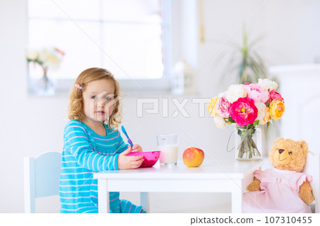 Baby eating vegetables. Solid food for infant. 107310455