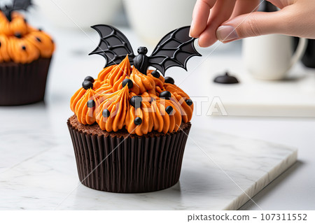 Halloween cupcake with bat topping 107311552