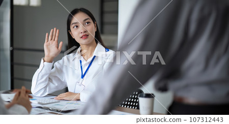 Asian business team meeting to analyze and discuss the situation on the financial report in the meeting room. Investment Consultant, Financial advisor and accounting concept 107312443