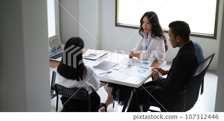 Asian business team meeting to analyze and discuss the situation on the financial report in the meeting room. Investment Consultant, Financial advisor and accounting concept 107312446