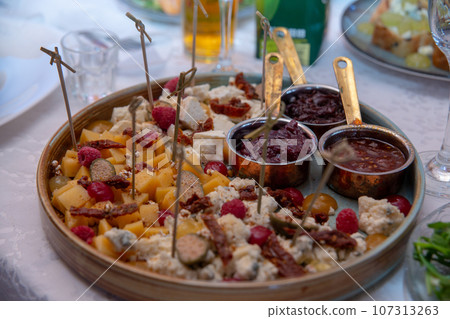 Catering plate. Assortment of snacks on the buffet table. 107313263