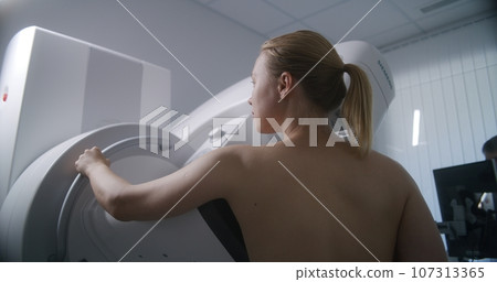 Adult woman does mammography scanning checkup in clinic Adult woman does mammography scanning checkup in clinic 107313365
