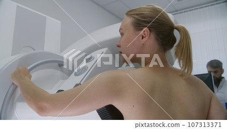 Adult woman does mammography scanning checkup in clinic 107313371