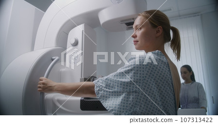 Female patient undergoing mammography screening procedure 107313422