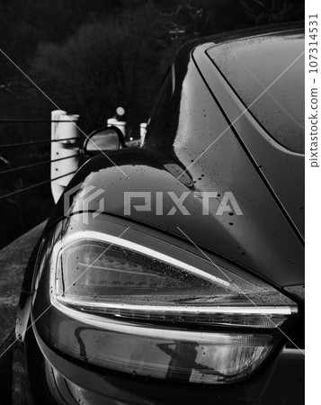 black sports car wet in the rain black sports car wet in the rain 107314531