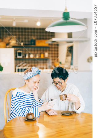 Young couple looking at smartphone together 107314557
