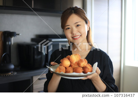 Woman with handmade sata andagi Woman with handmade sata andagi 107316437