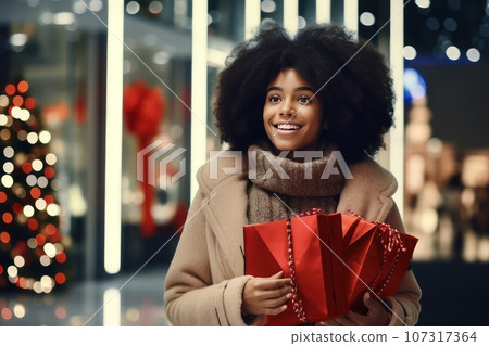 African American woman with a Christmas gift. Young black woman in a mall. African American woman with a Christmas gift. Young black woman in a mall. 107317364