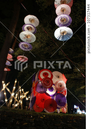Japanese umbrella and bamboo bathed in night light Japanese umbrella and bamboo bathed in night light 107317444