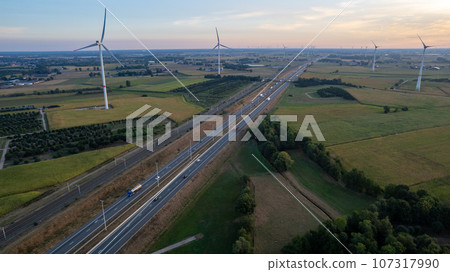 Sunrise Over Farmland, Windmills, and Highway Sunrise Over Farmland, Windmills, and Highway 107317990