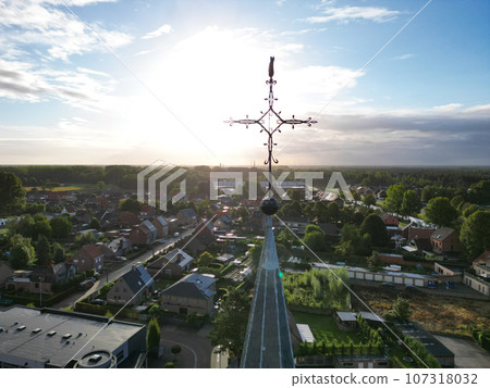 Heavenly Dawn: Church Cross Bathed in Sunrise Glow Heavenly Dawn: Church Cross Bathed in Sunrise Glow 107318032