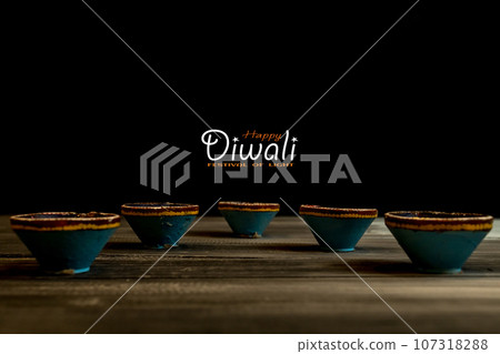 Happy Diwali - Clay Diya lamps lit during Dipavali, Hindu festival of lights celebration. Happy Diwali - Clay Diya lamps lit during Dipavali, Hindu festival of lights celebration. 107318288