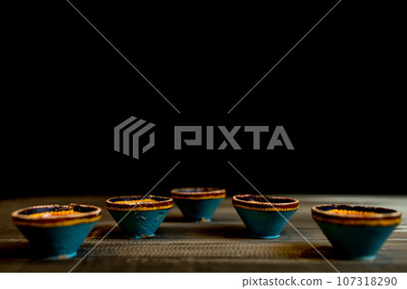 Happy Diwali - Clay Diya lamps lit during Dipavali, Hindu festival of lights celebration. Happy Diwali - Clay Diya lamps lit during Dipavali, Hindu festival of lights celebration. 107318290