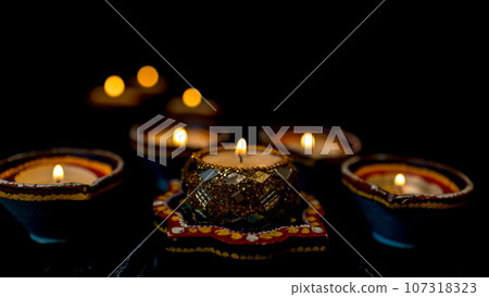Happy Diwali - Clay Diya lamps lit during Dipavali, Hindu festival of lights celebration. Happy Diwali - Clay Diya lamps lit during Dipavali, Hindu festival of lights celebration. 107318323
