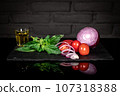Composition of fresh tomatoes, onion, basil, olive oil, dark background 107318388