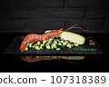 Prawn and zucchini on black background 107318389
