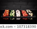 Fresh vegetables cutted in pieces, dark background 107318390