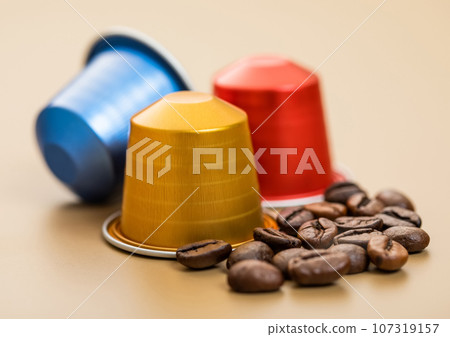 Fresh aroma natural organic coffee aluminium capsules pods on beige background 107319157