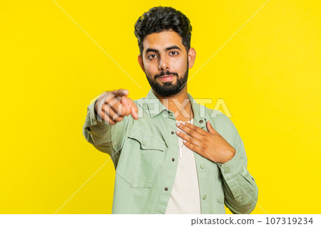 Happy Indian smiling man pointing finger to camera making winner choice, showing direction, select 107319234