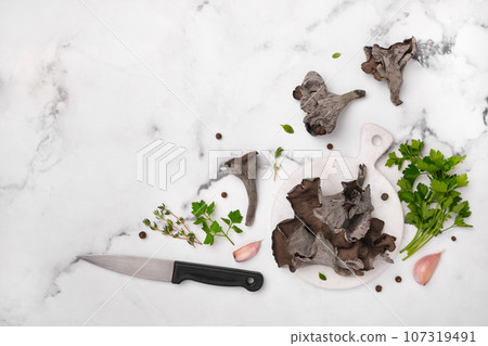 Black chanterelle mushrooms ready for cooking. Craterellus cornucopioides, or horn of plenty trumpet or of the dead Black chanterelle mushrooms ready for cooking. Craterellus cornucopioides, or horn of plenty trumpet or of the dead 107319491