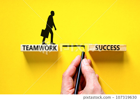 Teamwork success symbol. Concept words Teamwork success on wooden blocks on a beautiful yellow table yellow background. Businessman hand. Business and teamwork success concept. Copy space. 107319630